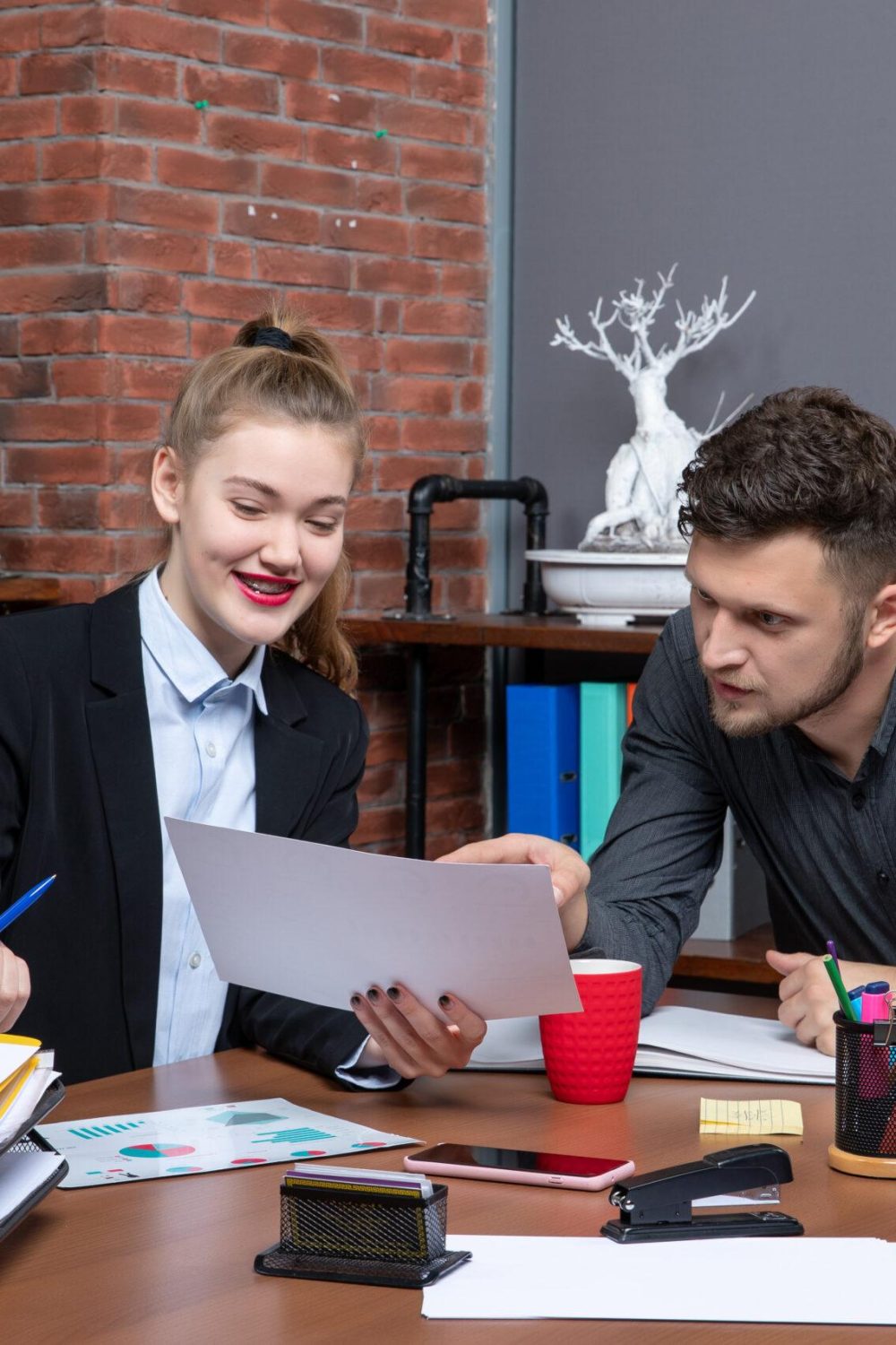 top-view-young-busy-clerical-workers-discussing-one-important-issue-document-office